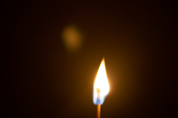Bright flame of a match in the dark