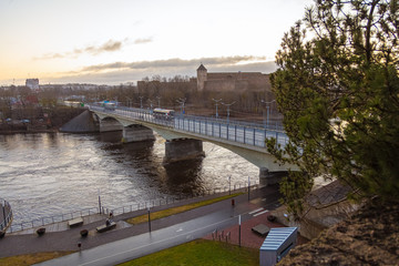Fototapeta premium view of the river and landscape under the bridge Walk under the bridge over the Narova River in the early morning.