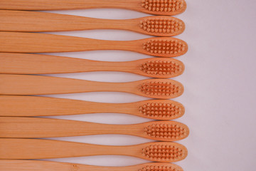 wooden bamboo toothbrushes on white background