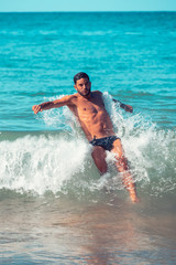 Young man Beach fun in the Caribbean Sea. Vacations.