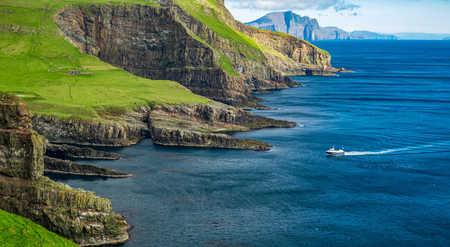 Boat arriving to Mykines island in Faroe islands