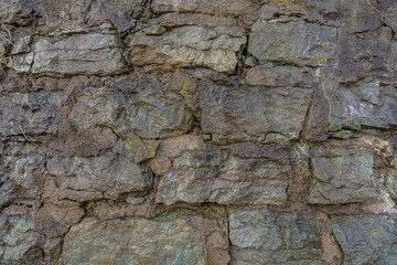Natural wet wall background. Limestone bricks.