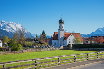 Fototapeta na wymiar village church wallgau at springtime, beautiful spa town in the bavarian alps