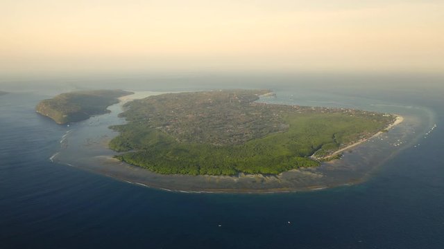 Aerial drone flight over little island near Bali, Indonesia, 4k