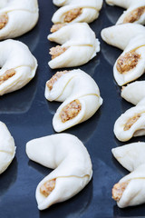 Cooking homemade bagels. Kneading dough, cutting and molding dough. Croissants in a black pan.