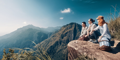 The company of young travelers look at the beautiful mountain peak "Adam's Peak" on the island of Sri Lanka.
