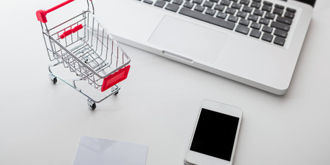Online shopping. Shopping cart, keyboard, bank card