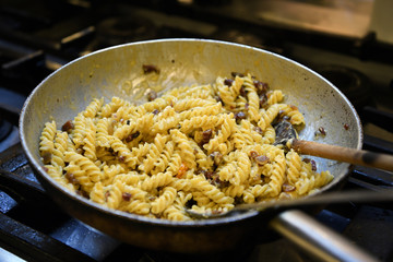 Making pasta in a restaurant. A pan full of pasta.