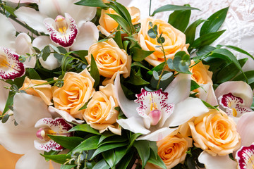 bouquet of white oridae with purple stigmas and yellow roses, bride's bouquet