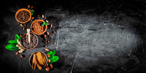 Obraz na płótnie Canvas Cocoa beans, cocoa powder, chocolate, cinnamon, coffee. Top view