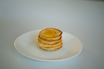 Sweet Homemade Stack of Pancakes with honey.