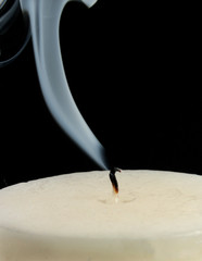 Smoking wick of extinguished candle