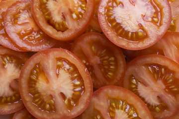 Excellent top view of sliced fresh red tomato