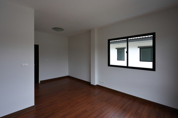 interior design empty white room with glass window and wooden laminate floor of a new residential house