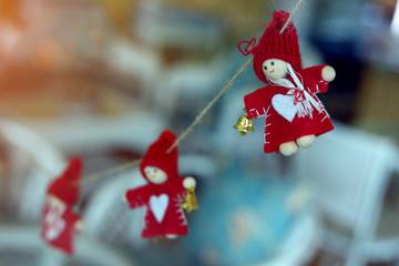 little christmas doll hanging decoration on glass window