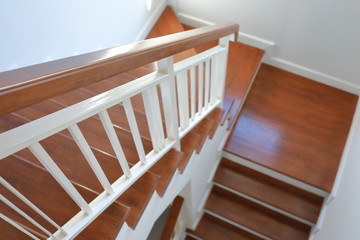 hardwood handrail banister and white steel balustrade on brown wooden stair interior decorated modern style of residential house