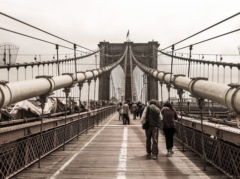 People Walking On Brooklyn Bridge Against Sky