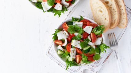 Salad with squid, cucumbers, tomatoes and lettuce. LCHF, FODMAP, paleo diet. Fresh spring vitamin mix.