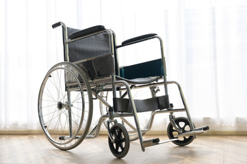 Fototapeta na wymiar Wheelchair in hospital room background with comfortable medical equipped in a hospital.