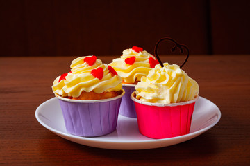 Cupcakes for Valentine's Day. Muffins decorated with hearts and delicious cream.