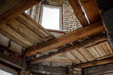 Wooden ceiling beams. Detail of house room interior under construction and renovation.