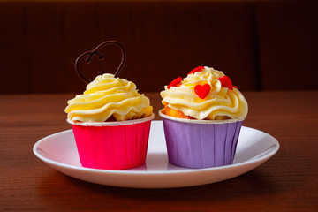Cupcakes for Valentine's Day. Muffins decorated with hearts and delicious cream.