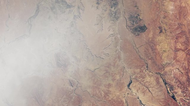 Famous mysterious human shape symbol in the sand in Australia desert, satellite view with moving clouds. Images furnished by Nasa