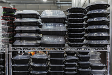 Plastic black containers with a transparent lid, stacked empty food containers