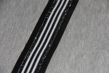 Black and white line with rhinestones on grey fabric