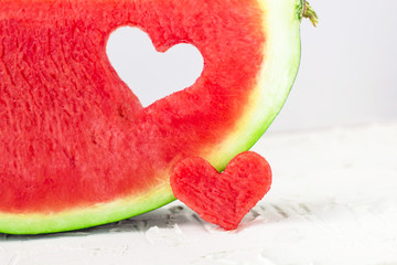 Obraz na płótnie Canvas Fresh juicy watermelon slice with heart shape hole on white background. Valentines, love, summer concept