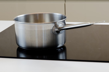 stainless steel cooking pot on  induction cooking plate, modern helper with low energy consumption...