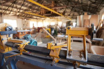 Large lathe inside of an industrial woodworking shop