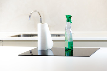 cleaning detergent with paper towels laid on a black induction cooker, easy maintenance, low...