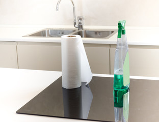 cleaning detergent with paper towels laid on a black induction cooker, easy maintenance, low...