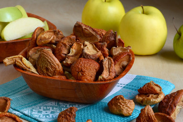 Apple dry slices in plate on napkins background