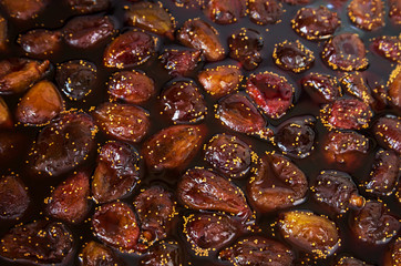 Fig jam. Fresh cooked colorful Fig jam with juicy brown fruit berries in liquid jam. Top view.