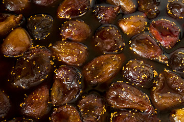 Fig jam. Fresh cooked colorful Fig jam with juicy brown fruit berries in liquid jam. Top view.