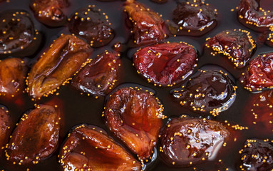 Fig jam. Cooked Fig jam with fruit berries in liquid jelly, close-up.
