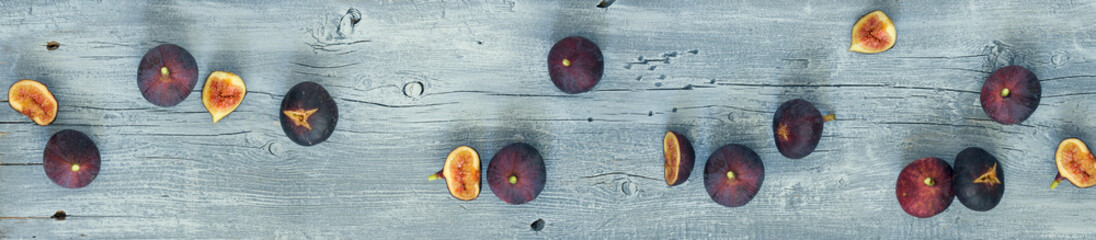 Extra wide wooden background with a Fig fruit. Blue rustic background and ripe figs for border or...