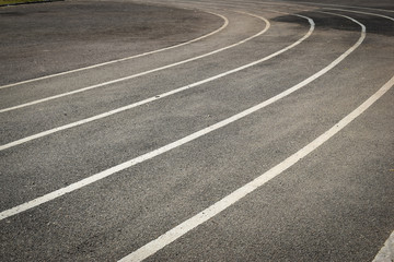 black tarmac asphalt of running track, athletic sport background