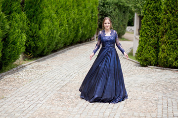 Fototapeta premium Beautiful girl in glamorous ultramarine dress. Ready for her prom night.