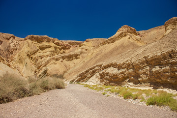 Fototapeta na wymiar desert canyon passage sand stone rocky mountain hills Israeli dry scenery landscape view of dangerous wilderness environment without people copy space