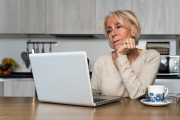 Retired woman watching the laptop
