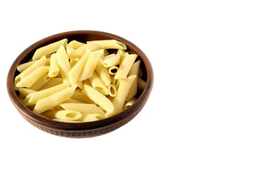 Pasta. Penne in a clay plate isolated.