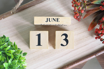 June 13. Date of December month. Number Cube with a flower camera and Sign wood on Diamond wood...