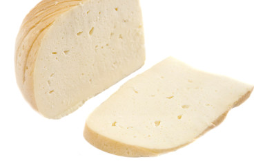 piece of smoked cheese isolated on a white background. Gullsky, Ukrainian cheese.