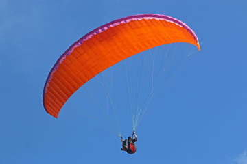 Paraglider flying wing in a blue sky	