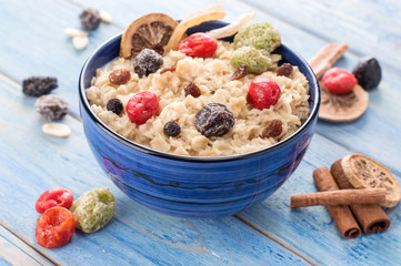 oatmeal with dried fruits on a blue wooden background