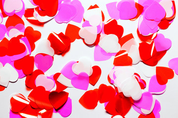 Colorful confetti in a heart shape on white background. Valentine day concept.