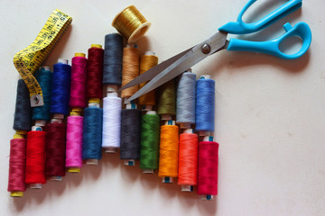 colorful spools of sewing thread on a white background